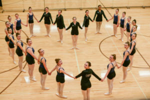 Dance students standing in a heart shape